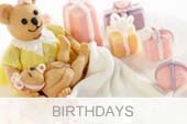 Birthday cakes with sugar paste figures.