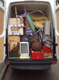 Picture of the rear of the van with back doors open, showing a full load ready to be taken to the new house.