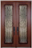 Normal shaped door with glass panels protected by ornate security grills.