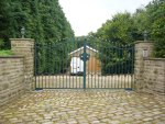 Ornate entrance gate fitted with rounded finials and matching handles.