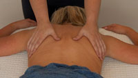 Lady having relaxing massage to her back, relieving tense, knotted muscles.