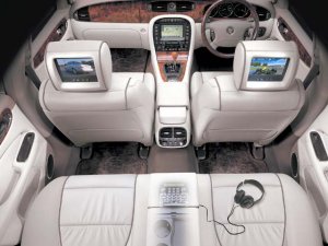Jaguar-XJ interior showing TV headrests, stereo, headphones, heated leather seats etc. These limousines are top of the range with every added extra.