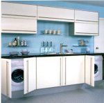Delta Kitchen in Ivory from William Ball Kitchens with open doors showing washing machine and tumble dryer.