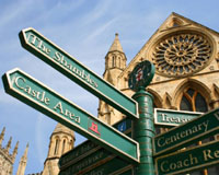 Image of a signpost in York City pointing the way to The Shambles, Castle Area etc.
