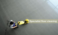 Man seen using single disc machine on hard floor providing specialist floor care.