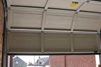 View of sectional garage door from inside the garage.