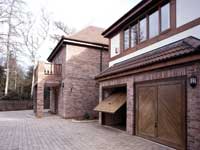 Double up and over garage doors in wood effect.
