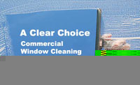 This image shows a window covered in soap with a hand holding a squeegee. The text says A Clear Choice; CommercialWindow Cleaning Contracts.