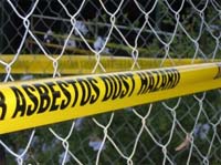 Asbestos warning yellow tape fencing of an area.