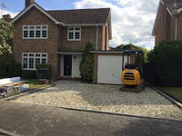 Image shows a drive with all debris removed, and base levelled with mini digger, ready to lay down blocks.