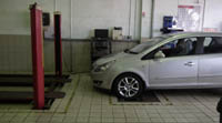 Car on rolling road for MOT brake testing.