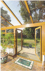 Looking from the inside of a conservatory to the outside through the open patio doors.