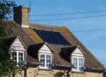 Solar collection tubes on house with dormer windows.
