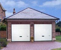 Double garage with white pvc-u doors.