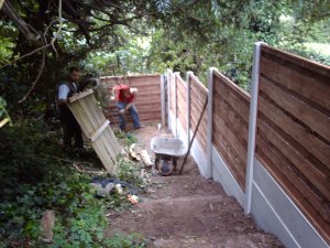 Work in progress - plain gravel boards with concrete posts and horizontal waney lap fencing panels.