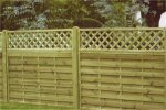Straight panel garden fence with wooden posts, topped with flat topped diamond trellis.