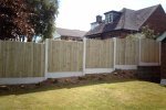 Completed garden fence with concrete posts and plain gravel boards. Fencing panels are vertical close board, or VCB.