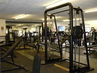 Main gym area showing smith machine and weight benches.