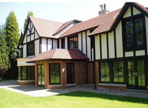 Front of large detached property in black and white with a variety of pvc-u products.