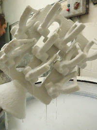 Investment process, dipping the mould into slurry.