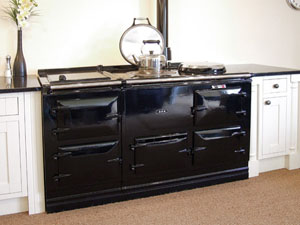 Black refurbished Aga cooker with 4 ovens.