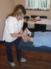 Patient receiving physiotherapy treatment to ankle after surgery to help scar reduction.