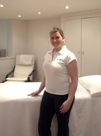 Physiotherapist Vick Cork, in one of her clinics standing by the physio table.