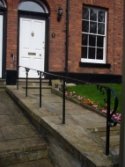 Simple balustrade or handrail separating two terraced properties.