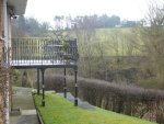 Extended ornate balcony over uneven ground.