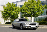 Top cars jaguar on a tree lined street