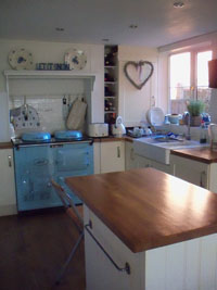 Kitchen with a blue Aga cooker.