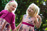 Picture of two blond haired little girls as bridesmaids.