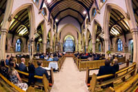 Picture taken inside of church during service with fish eye lense. This makes the arches appear to bend in towards the aisle.