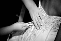 Bride fastening her Wedding Dress