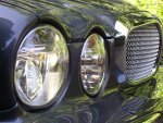 Jaguar XJ limousine front end showing headlights and grille.