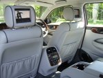 Jaguar interior showing leather seats and TV headrests.