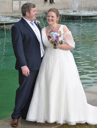 Bride and groom with a marina backdrop.