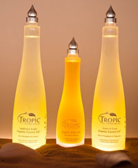Creative product shot of three bottles of Tropic natural skin care products.