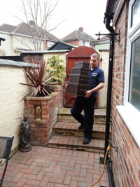 Grocotts staff in branded clothing carrying boxes.