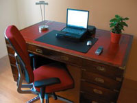 Beautiful office desk with red leather inlay, representing Grocotts furniture dismantling and reassembly.