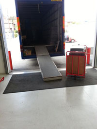 Ramp into rear of removal van, unloading property into secure storage.